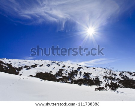snowy mountains Australia sunny day with cloud winter nature landscape over snow and rocks at ski resort