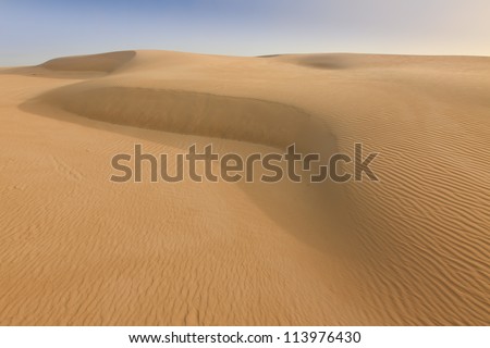 Sand dune desert day time dry wave of wild unexplored terrain hot and extreme place