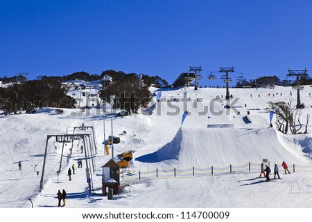 Ski resort winter season mountain slope with people sport skiing and snowboarding day time sunny weather