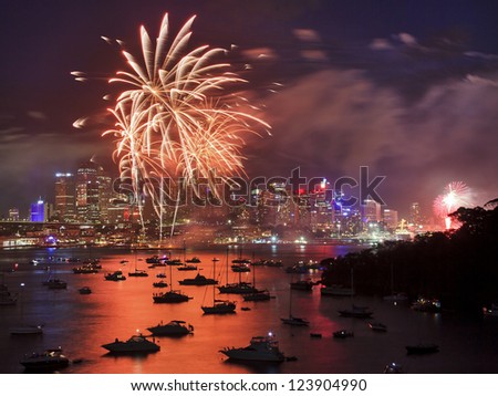 firework in Sydney new year eve event celebration bright pyrotechnic lights reflect in harbor water over city CBD