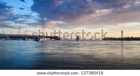 australia sea port harbour at sunrise marina protected area with lighthouse and fishing boat exiting