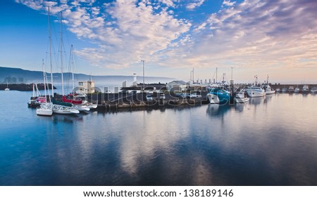 australia protected bay still water sunrise time fishing boats at piers around lighthouse industrial fleet nautical business