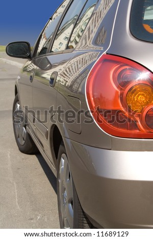 modern car rear side-view varnished with reflection on side