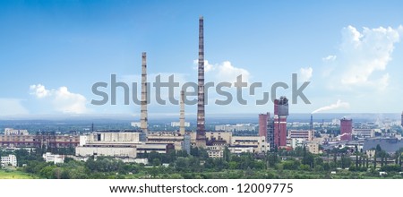 panorama of chemical plant with high chimney, industrial smoke and blue sky