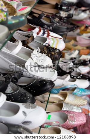 the retail shop shoes shelf with child shoes arranged in perspective