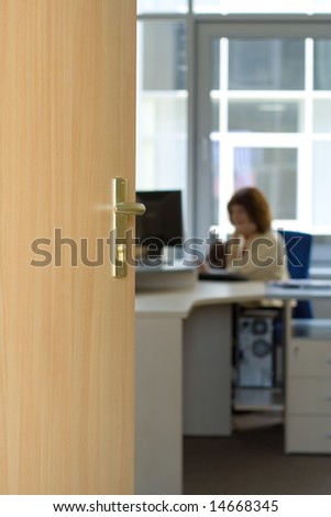 office space open door access to room women working computer desk