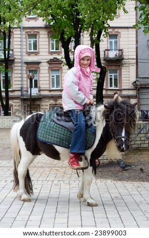 child horseback pony riding city park spring season