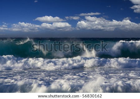 high strong ocean waves with spray and surf under blue cloudy summer sky pacific coast australia
