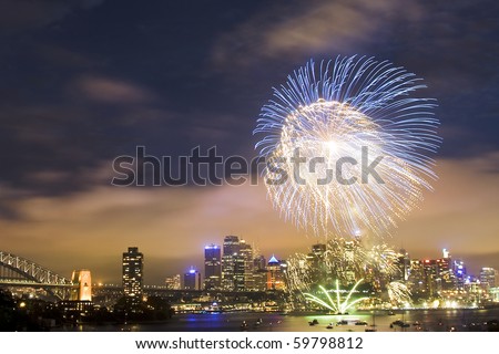 sydney australia CBD night scene new year fireworks celebration pyrotechnics ball high in dark sky color illumination