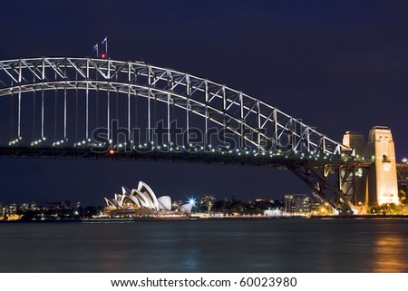 sydney australia harbour bridge opera house night scene highlighted illuminatoin by lights blue sky