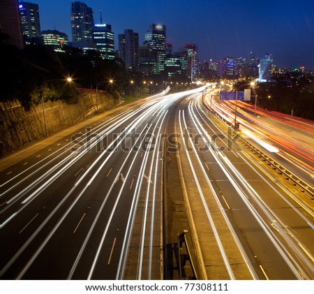 dark city highway motor road with blurred long exposure vehicle light lane cityscape twilight movement