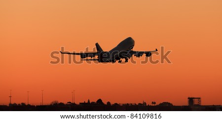 huge airplane departures airport at sunset background orange clear plain sky