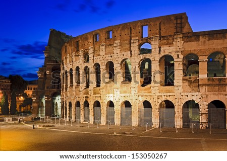 Italy rome coliseum ancient amphitheatre for sport events Caesar historic landmark illuminated at sunrise side view