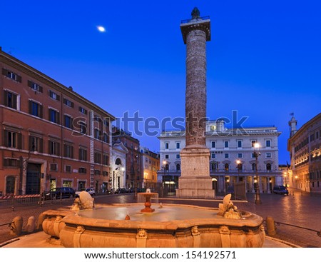 Italy Rome capital of roman empire piazza colonna with column of Marcus Aurelius at sunrise with moon light and full moon in blue sky