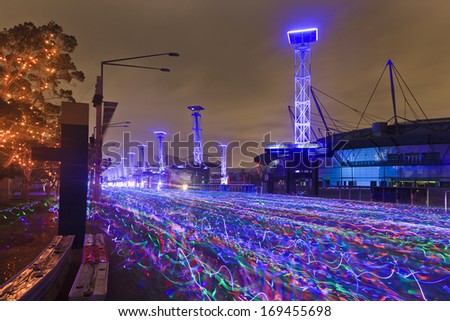 sydney electric run charity running festival after sunrise blurred river of racing athletes with neon glow sticks at olympic park