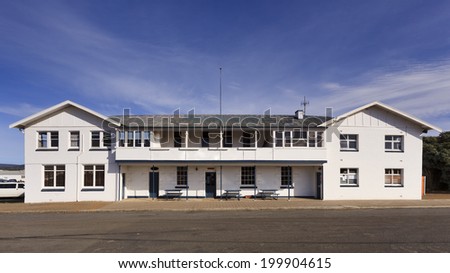 australia rural town historic hotel on the road white facade with entrance and pub tables sunny morning