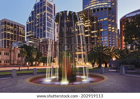 Australia sydney city CBD landmarks at sunset flowing illuminated modern fountain in the street with skyscrapers in background