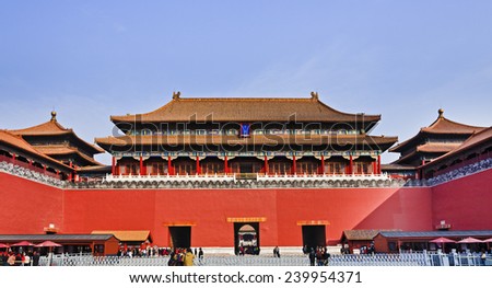 China Beijing Forbidden city main entry palace and gate with entry points and people crowds going through red defensive walls to ancient empire landmark