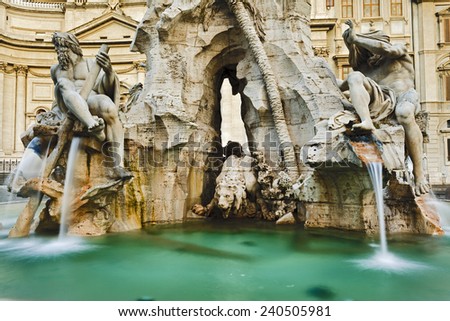 Italy Rome Navona square 4 rivers fountain with statues of gods and rivers flowing streams of water