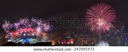Australia SYdney New Year fireworks distant panoramic view of light show over city CBD and harbour bridge at midnight