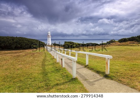 Great Ocean road in VIctoria, Australia, Otway lighthouse at day time from the land with fenced walkway in foreground