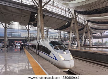 Beijing train station platform with boarding fast train for traveling people to quickly reach destination