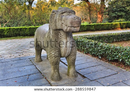 SIngle statue of mystical creature half lion half dragon made of stone in an alley to Ming dynasty emperor's tomb in Nanjing, China