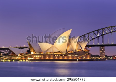 SYDNEY, AUSTRALIA, 10 JULY 2015 - Sydney opera house and Harbour bridge in Sydney at sunset. Iconic and world famous landmark of Australia viewed from Mrs Macquarie point in Royal Botanic Garden