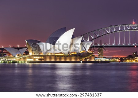SYDNEY, AUSTRALIA, 10 JULY 2015 - Sydney opera house and Harbour bridge in Sydney at sunset. Iconic and world famous landmark of Australia viewed from Mrs Macquarie point in Royal Botanic Garden