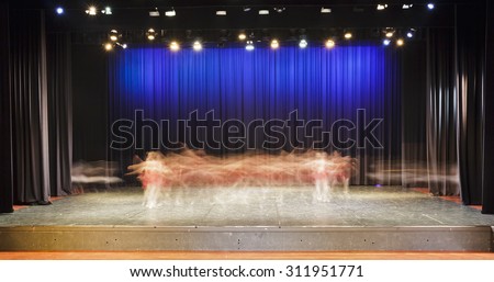 on stage dressed ballet performance in a theater blurred motion movements of dancers under stage lights