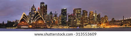 Panorama of SYdney City CBD from Kiribilli across Sydney Harbour at sunrise when downtown is brightly illuminated