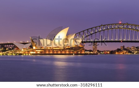 SYDNEY, AUSTRALIA, 10 JULY 2015 - Sydney opera house and Harbour bridge in Sydney at sunset. Iconic and world famous landmark of Australia viewed from Mrs Macquary point in Royal Botanic Garden