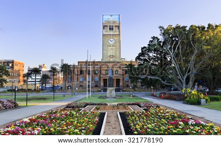 newcastle Australia ?own hall facade from park with blooming flowers during reconstruction of clock tower