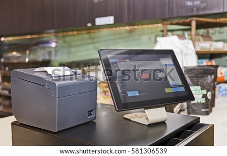 Point of Sale retail service computerised terminal in coffee shop. Touch screen tablet based with software interface for waiters with cash register and mobile print terminal.