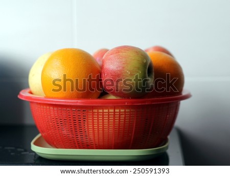 Fruits (Apple, Orange and Pear) in Red Basket After Washing, Ready to be Served or Cut to Slices