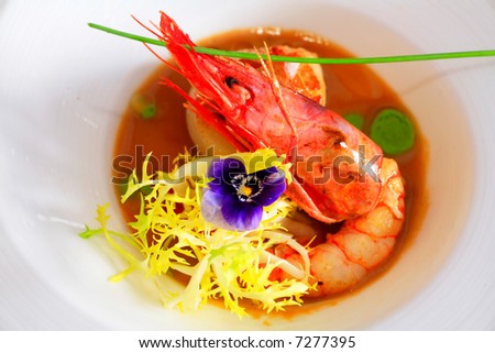 fancy food arrangement with cooked shrimps and salad in a restaurant
