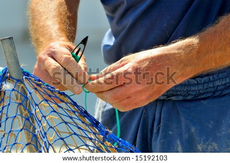 man knitting fishing net