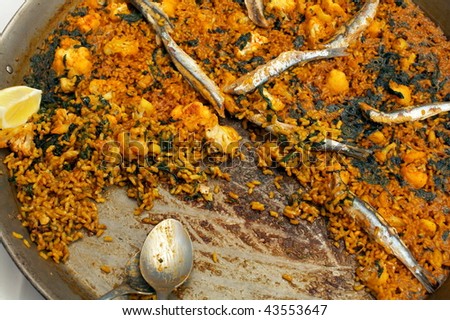 paella/traditional spanish food with rice and fish