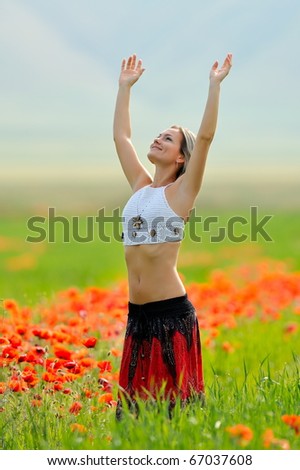 young beautiful woman on flower field in summer