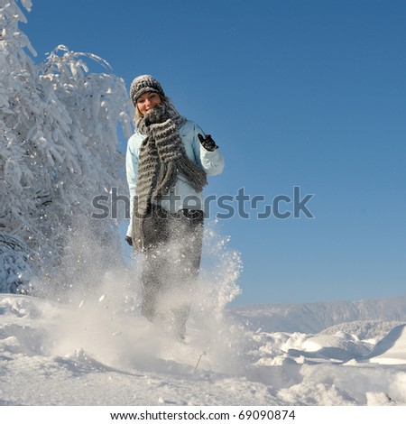 young woman outdoor in winter enjoying the snow
