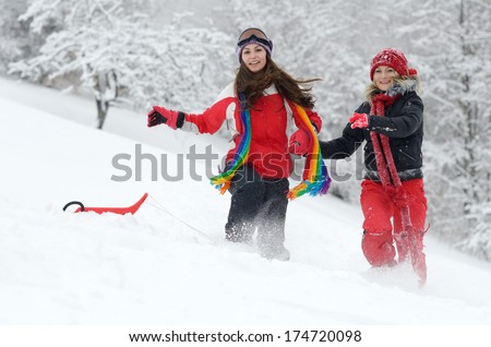 young happy women outdoor in winter enjoying the snow