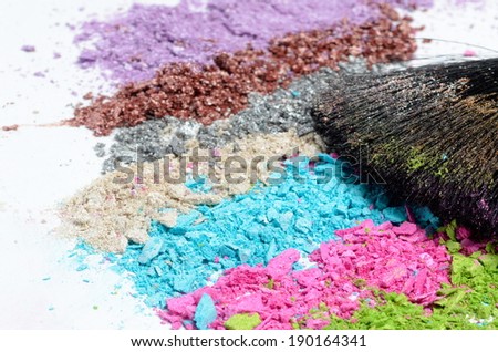 professional make-up brush on colorful crushed eyeshadow