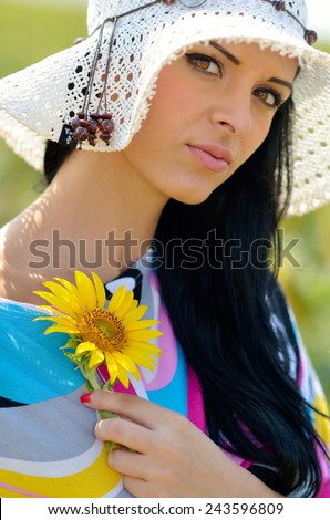 young pretty woman on blooming field in summer