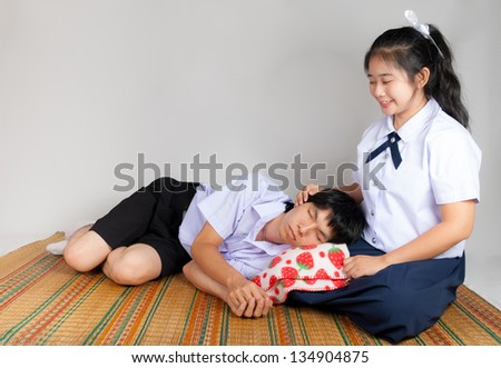 Boyfriend lies down on girlfriend\'s lap in high school uniform