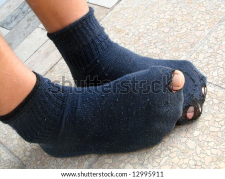 stock-photo-boy-in-old-and-torn-socks-12995911.jpg