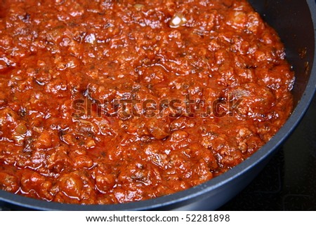 Spaghetti bolognese sauce on a pan on a stove
