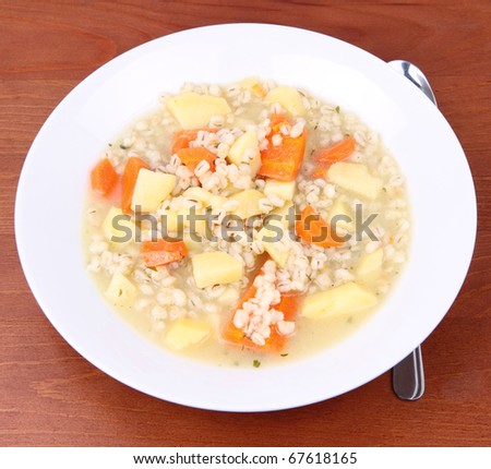 Barley soup on  a wooden background