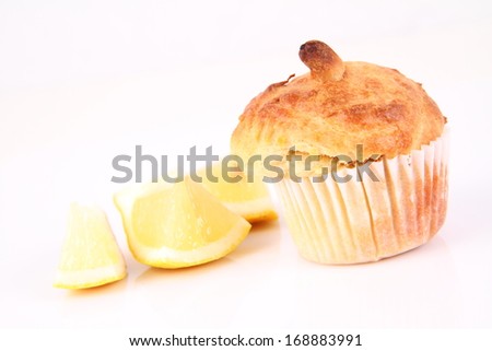 Lemon muffin and lemon pieces on a white background