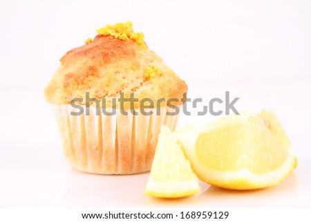 Lemon muffin and lemon pieces on a white background