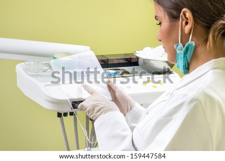 Dentist working on future tablet. Tablet is blank.